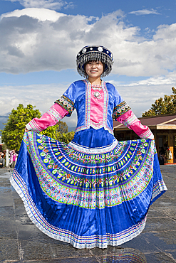 Woman wearing a traditional colourful dress, Dali, Yunnan Province, China