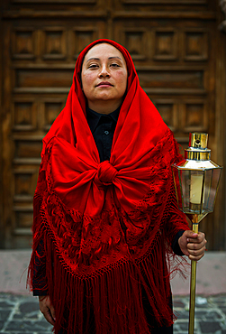 Women wearing traditional Potosi rebozos and carrying candles,