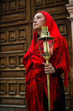 Women wearing traditional Potosi rebozos and carrying candles,