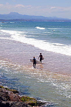 Surfers on Cote des Basques beach at sunset, Biarritz