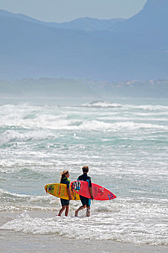 Surfers on Cote des Basques beach at sunset, Biarritz