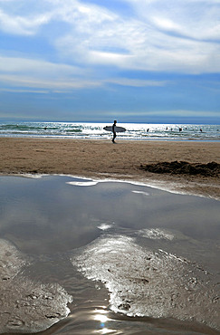 Surfers on Cote des Basques beach at sunset, Biarritz