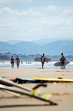 Surfers on Cote des Basques beach at sunset, Biarritz