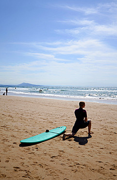 Surfers on Cote des Basques beach at sunset, Biarritz