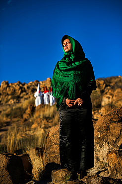 Women wearing traditional Potosi rebozos and carrying candles,