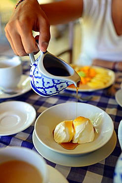 Young attractive woman having breakfast in The Dutch House hotel, Galle, Sri Lanka