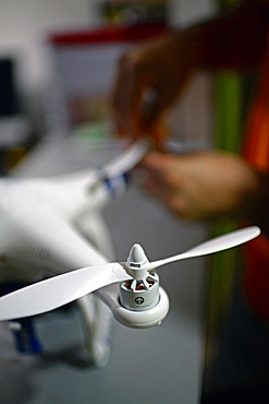 Young man mounting propeller blades on Phantom Drone