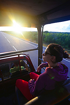 Young woman on safari jeep at Udawalawe National Park, Sri Lanka