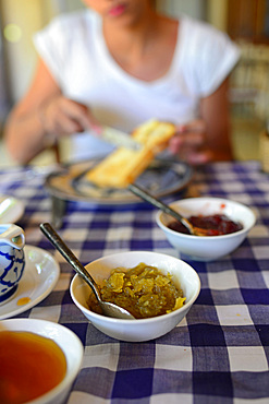 Young attractive woman having breakfast in The Dutch House hotel, Galle, Sri Lanka