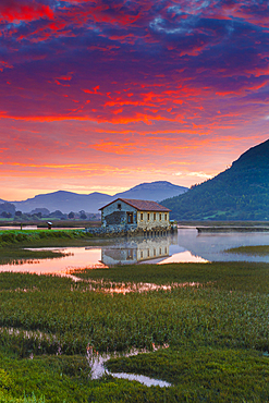 Salt marshes at dusk. Cerroja water mill. Santoￃﾱa, Victoria and Joyel Marshes Natural Park. Cantabria, Spain, Europe.