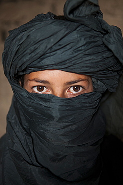 Afghan boy with a turban around his face