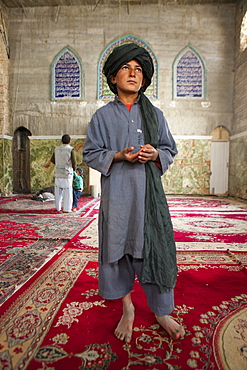 Afghan boy in front of a shia mosque in kabul