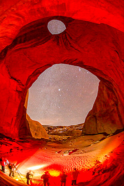 A group of photographers in a photo workshop taking pictures at night in Monument Valley Navajo Tribal Park, Arizona.