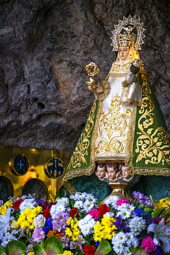 Our Lady of Covadonga. The Blessed Virgin Mary, and a Marian shrine devoted to her at Basílica de Santa María la Real de Covadonga catholic church in Cangas de Onis, Picos de Europa, Asturias, Spain, Europe.
In 1777 a fire destroyed the old temple, which stood adjacent to the Holy Cave where Our Lady of Covadonga is revered. It was then decided to raise a new church as a monumental sanctuary, raising donations from all of Spain; the plan was opposed by the local council, as the canons wanted to rebuild the temple of the Holy Cave and build an ambitious sanctuary that had once been designed by Ventura Rodríguez, but never completed. One century later, the project was resumed by King Alfonso XII of Spain, who was interested in completing this work. The classic design of Ventura Rodríguez was very difficult and expensive and was replaced by a new neo-Medieval design.