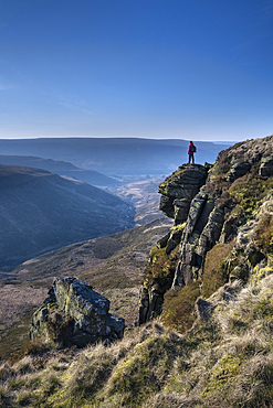 Walker looking over Crowden Great Brook valley from Laddow Rocks, Peak District National Park, Derbyshire, England, United Kingdom, Europe