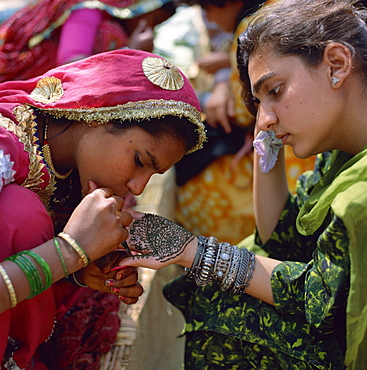 Girl having henna tattoo painted on her hand for festive occasion, Rajasthan, India, Asia