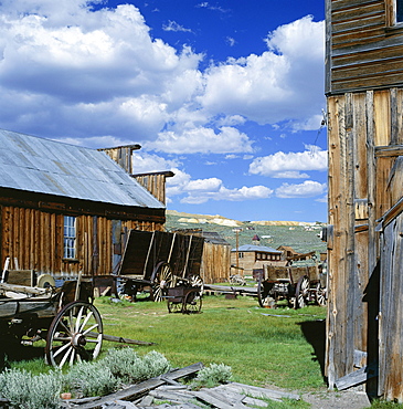 Wooden buildings and carts at Bodie, Ghost Town, Bodie State Historic Park, California, United States of America (USA), North America