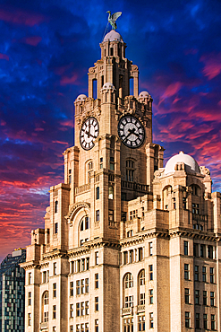 Liver Building in Liverpool, UK against a dramatic sunset sky