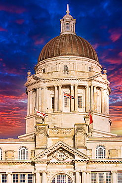 Historic building with a dome against a dramatic sunset sky in Liverpool, UK.