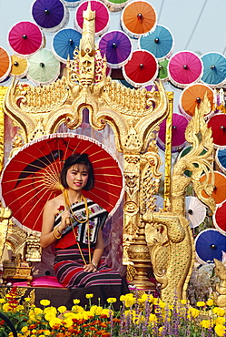 Portrait of a woman with umbrella seated on a golden throne in a parade in Chiang Mai, Thailand, Southeast Asia, Asia