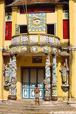 Small boy on steps of the rural Cao Dai temple in Tay Minh Province, Saigon, Vietnam, Indochina, Southeast Asia, Asia