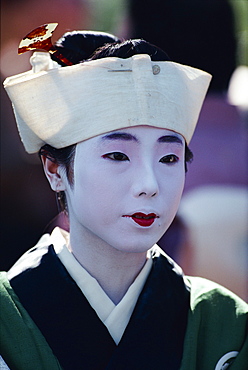 Portrait of a woman with white face make-up and hat of the Heian period during the Festival of Ages in Kyoto, Japan, Asia