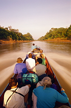 Tourists in longboat on a river in the Mulu National Park in Sarawak, Borneo, Malaysia, Southeast Asia, Asia