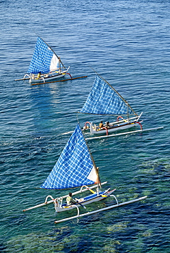 Fishing boats with blue check sails off Cape Jambela on the east coast of the island of Bali, Indonesia, Southeast Asia, Asia