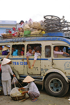 Crowded bus with bicycles, sacks and passengers on roof, city bus terminal, Nha Trang, Vietnam, Indochina, Southeast Asia, Asia