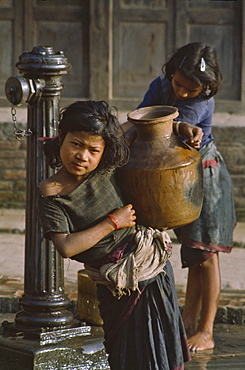 Girl carrying water bottle in Bhaktapur, Nepal, Asia