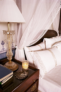 Detail of side table and four poster bed in bedroom, Lutyens style bungalow, New Delhi, India, Asia 