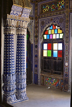 Painted walls, traditional lotus based columns and stained glass window, Mehrangarh Fort, Jodhpur, Rajasthan state, India, Asia