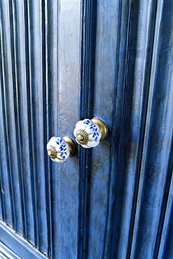 Detail of reproduction hand painted china cupboard door knobs in a home, near Ahmedabad, Gujarat state, India, Asia