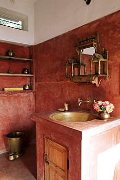 Pink finished plaster walls and hand beaten brass bathroom sink, residential home, Amber, near Jaipur, Rajasthan state, India, Asia