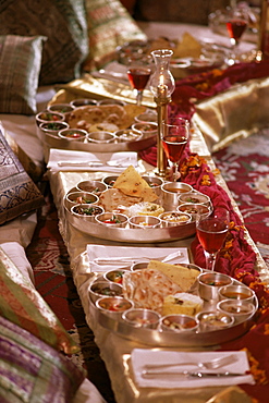 Traditional Rajasthani food served in traditional brass thalis in the Grand Durbar Hall, Samode Palace, Samode, Rajasthan state, India, Asia