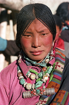 Portrait of a Tibetan nomad woman with turquoise and silver jewellery, at Tongren, Qinghai, China, Asia