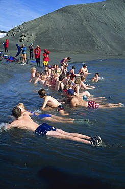 Passengers from a cruise ship at hot tub in warm volcanic waters on Deception Island, Antarctic Peninsula, Antarctica, Polar Regions