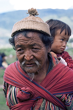 Old man carrying child, Bhutan, Asia