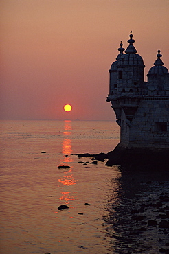 Turrets of the 16th century Belem Tower silhouetted in the sunset, in Lisbon, Portugal, Europe