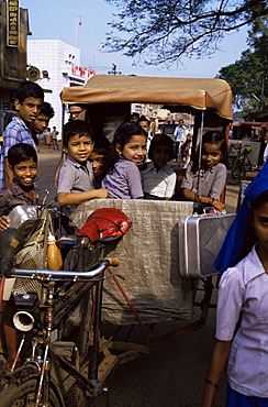 Schoolchildren in cycle rickshaw, Aleppey, Kerala state, India, Asia