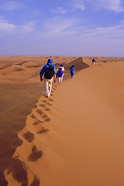 Party of trekkers on top of dunes at Chigaga, Draa Valley, Morocco, North Africa
