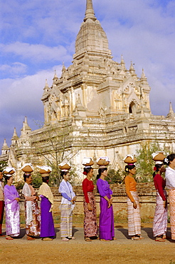 A line of women at a ceremony for the ordination of Buddhist monks, Bagan (Pagan), Myanmar (Burma), Asia