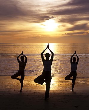 Yoga on the beach at sunset