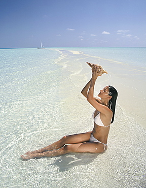 Girl with seashell, Maldives, Indian Ocean, Asia