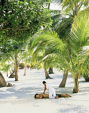 Man having a massage on the beach, Southeast Asia, Asia