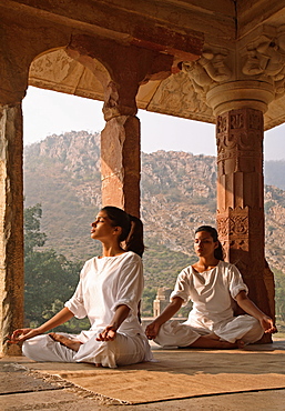 Women practising yoga in the abandoned town of Bhangarh, Alwar, Rajasthan, India, Asia