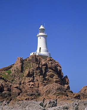 Lighthouse on rocks at Corbiere Point on the island of Jersey, Channel Islands, United Kingdom, Europe