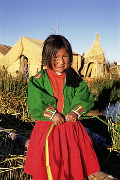 Portrait of a Uros Indian girl on a floading reed island, Islas Flotantes, Lake Titicaca, Peru, South America