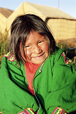 Head and shoulders portrait of a Uros Indian girl on floating reed island, Islas Flotantes, Lake Titicaca, Peru, South America