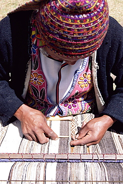 A Peruvian man weaving, Sacred Valley area, Peru, South America